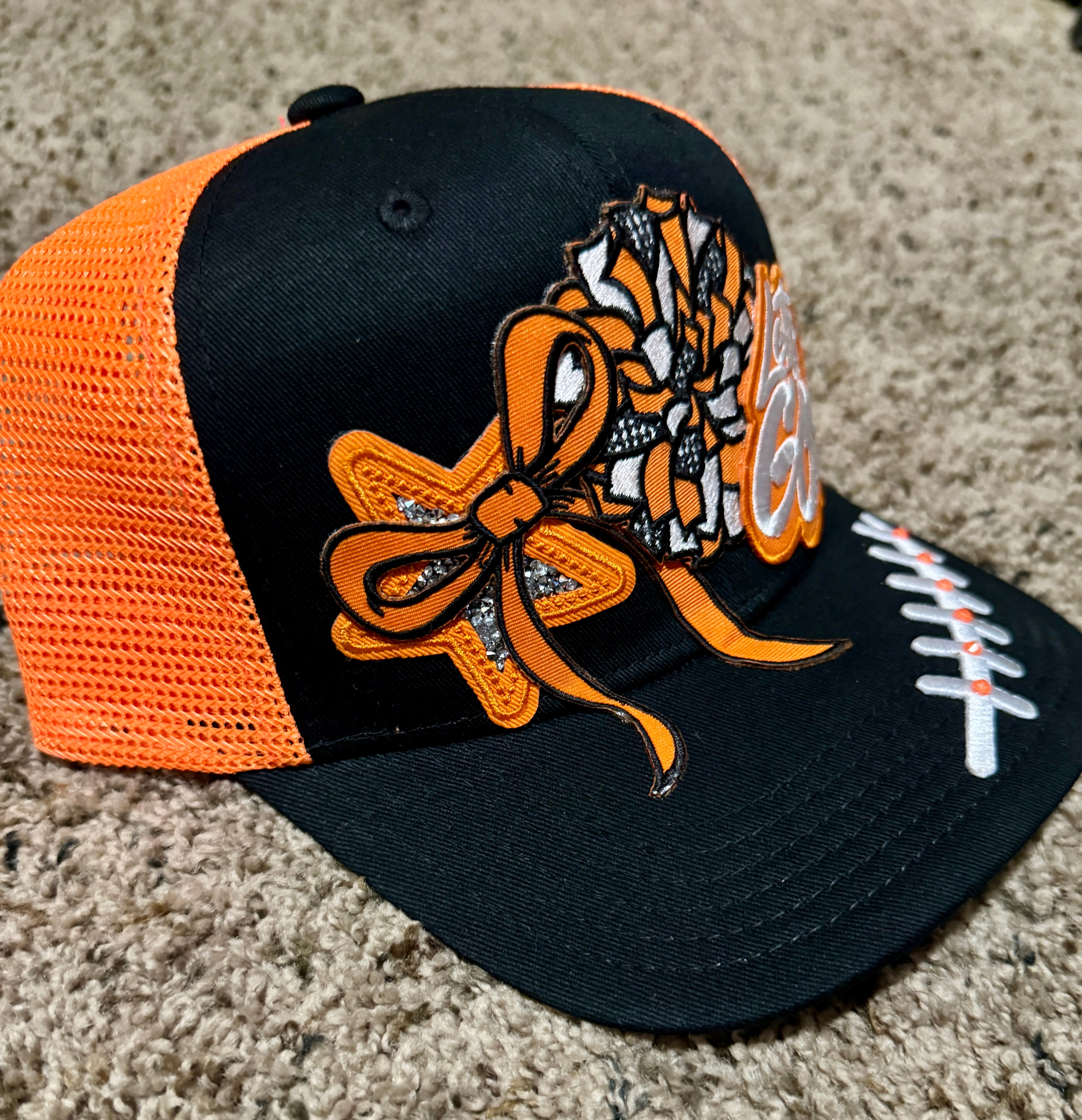 “Let’s Go!” Game Day Trucker Hat – Black & Orange Mesh, Cheer Bow & Football Patch Cap