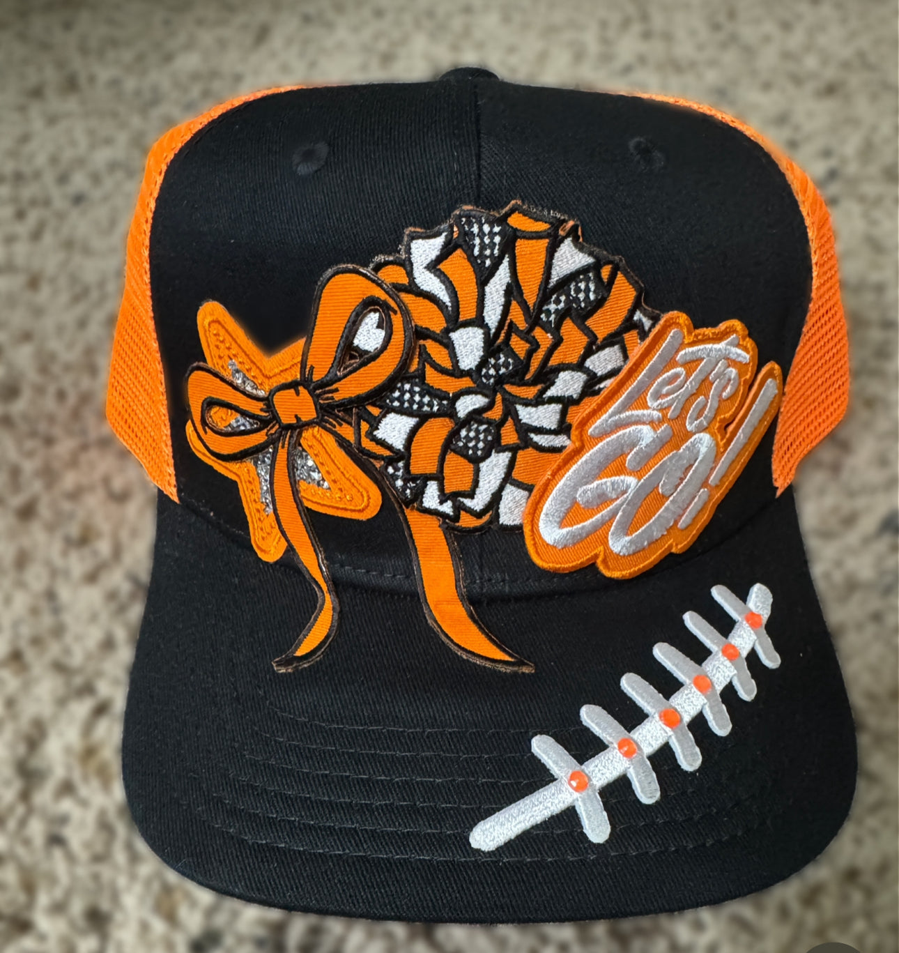“Let’s Go!” Game Day Trucker Hat – Black & Orange Mesh, Cheer Bow & Football Patch Cap